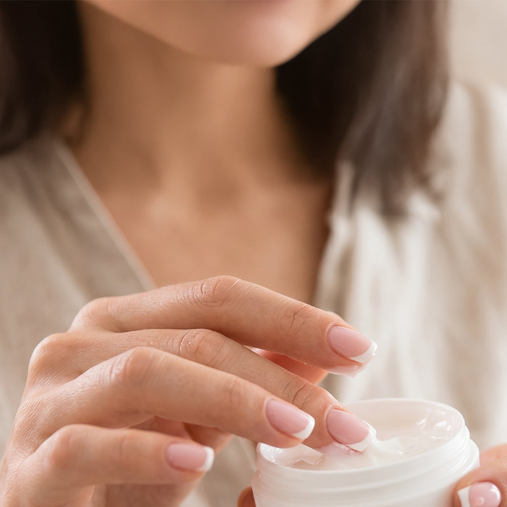 A woman taking out moisturiser from a container