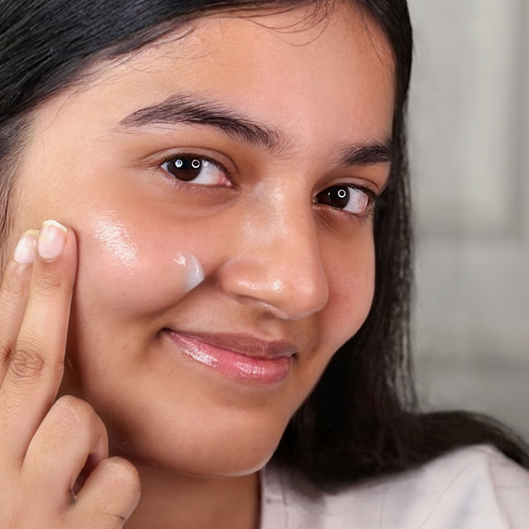 Girl Applying Moisturiser On Face 