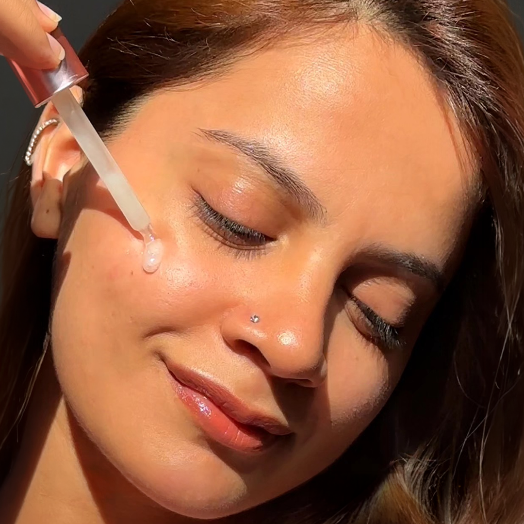 Girl Applying Serum On Face