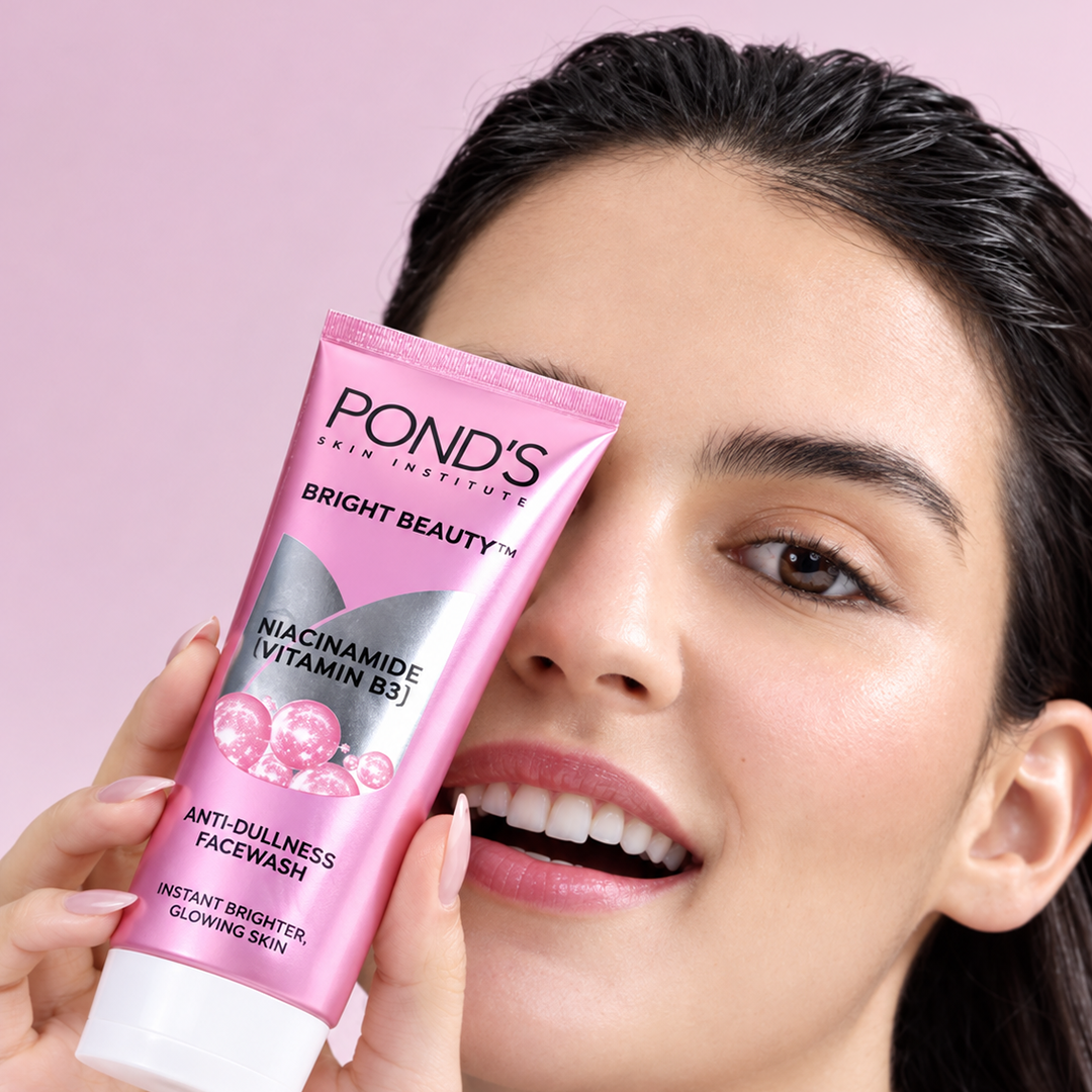 A girl with glowing skin holding the POND'S Bright Beauty Facewash