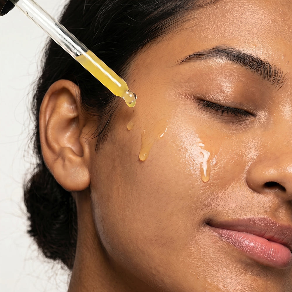 a girl applying serum with a dropper