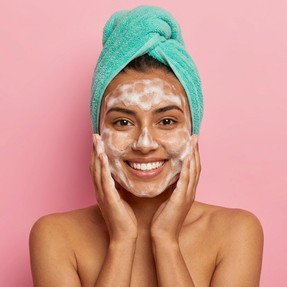 A young woman washing her face